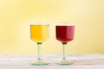 two glasses of wine, red and white, on the table