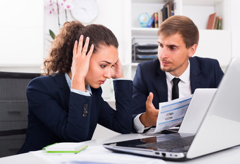 sad business colleagues in office .