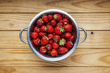Strawberries ripe and red, fresh from picking, wooden background.