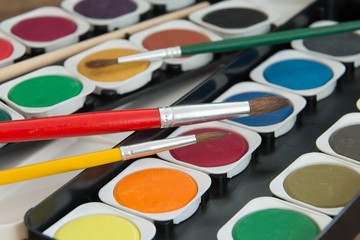 watercolor paints set with brushes