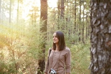 Young lady in a pine forest