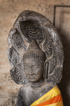Buddha head within a a seven naga. East Mebon temple, Angkor, Cambodia