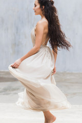 Fototapeta na wymiar Bride dancing in a long gentle silk dress fineart style