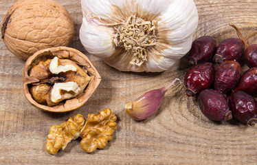 Fototapeta na wymiar Dried fruit of hawthorn, garlic and walnuts. The concept of alternative medicine.