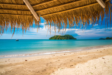 Beautiful tropical island beach in sunny day blue sky background. Summer tropical travel holiday vacation or green nature concept.