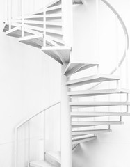 white steel spiral staircase and white wall