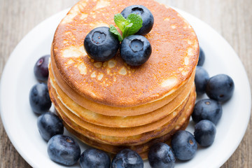 Stack of pancakes with blueberry and fresh berry.