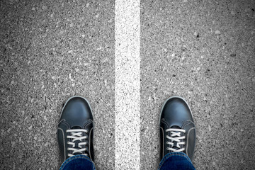 Black casual shoes standing over white line