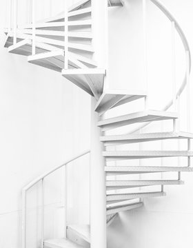 white steel spiral staircase and white wall