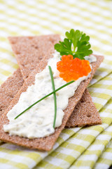 Crispbread with soft cheese with herbs and bacon.