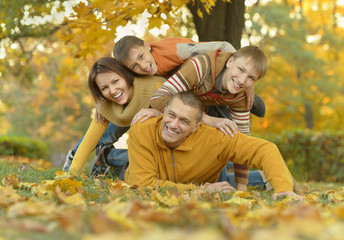 Happy family in autumn forest