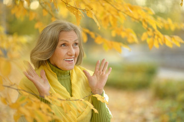 Surprise senior woman in autumn