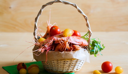 Food. shrimps, cherry tomatoes, wooden background
