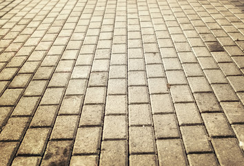 sunlight on paved cobblestone pavement
