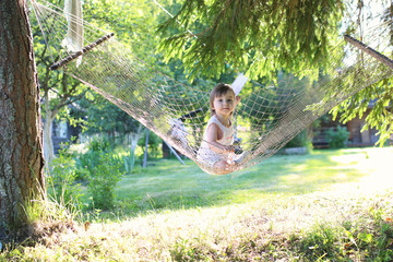 little girl in hammock nature summer