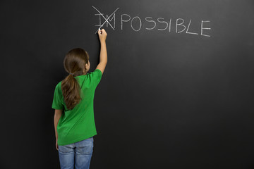 Girl writing in a blackboard