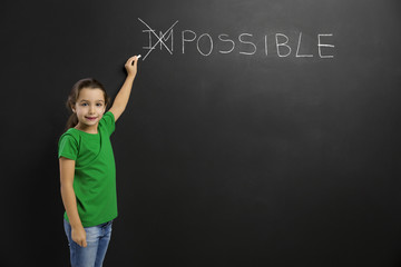 Girl writing in a blackboard