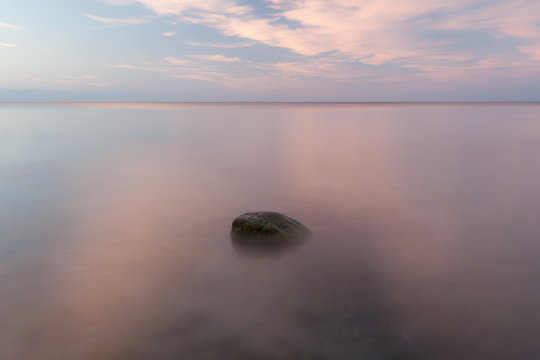 Long exporsure of a stone at sunset. Calm summer evening at the island of Gotland in the Baltic sea.