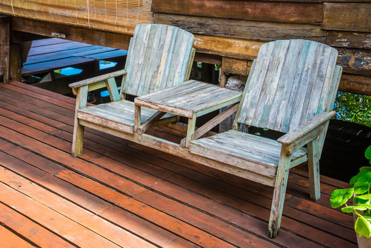 Outdoor wooden bench in resort - exterior decoration concept.