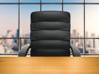 wooden table with office chair on office building background