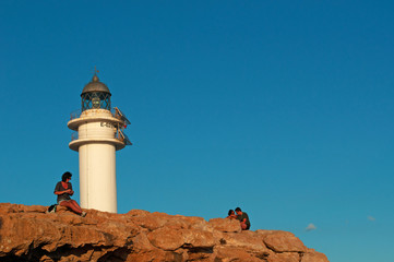 Fomentera, Isole Baleari: turisti al faro di Es Cap de Barbaria, costruito nel 1972 all&rsquo;estrema punta sud dell&rsquo;isola, al tramonto il 5 settembre 2010