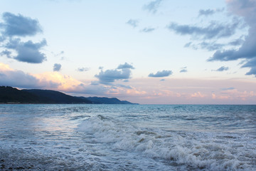 Raging surf waves on the beach after the storm of the mountainous coast
