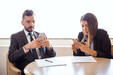 Business people distracted with their smartphones