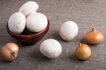 Raw champignon mushrooms and onions