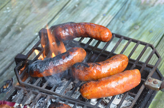 Flames, smoke, sausages on grill
