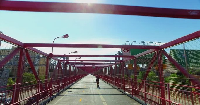 A perspective view on the pedestrian sidewalk on the Williamsburg Bridge over the East River in Manhattan.  	