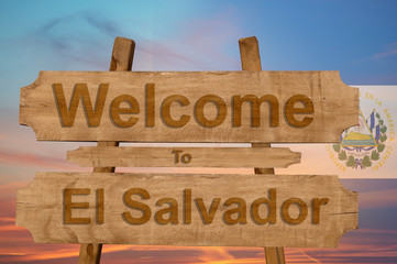 Welcome to El Salvador sing on wood background with blending national flag