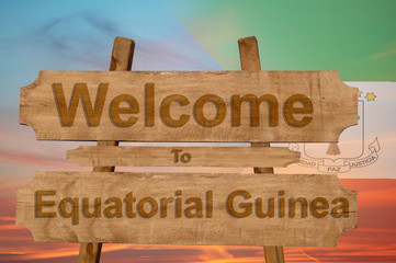 Welcome to Equatorial Guinea sing on wood background with blending national flag