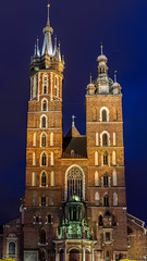 facade of main church in krakow in market square at night