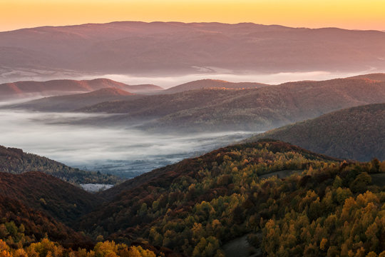 cold autumn morning fog on red hot sunrise in the Carpathian mountains