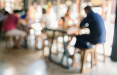 Coffee shop blur background with bokeh image .