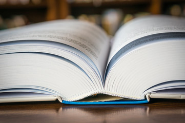 Open book on the table in a library