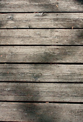 Dark, brown, scratched wooden cutting board. Wood texture