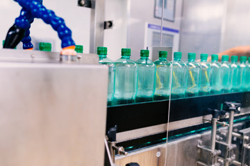 Water bottling line for processing and bottling pure mineral carbonated water into bottles. Selective focus.