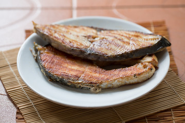 A fried fish on plate.