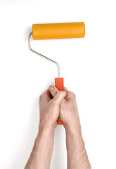 Close-up hands of man holding a paint roller.