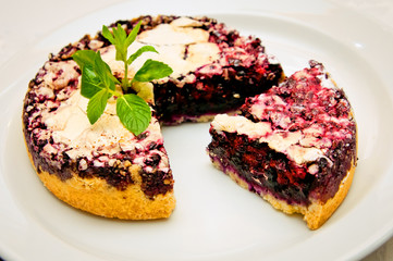 piece of cake is cut from a piece of berry cake with a dark filling