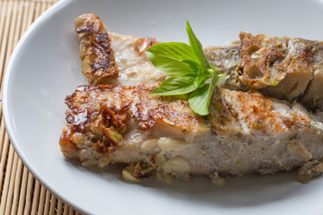 A fried fish on plate.