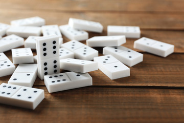 Heap of dominoes on wooden table