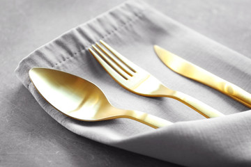 Table setting with cutlery and napkin, closeup