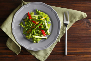 Tasty salad with asparagus and vegetables on plate