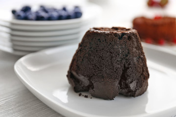 Tasty chocolate fondant on white plate, closeup