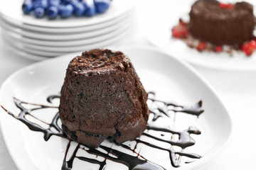 Tasty chocolate fondant on white plate, closeup