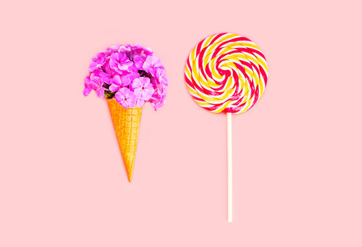 Ice cream cone flowers and colorful lollipop caramel on stick ov