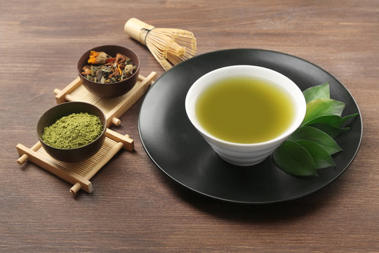 Green matcha tea set on wooden background