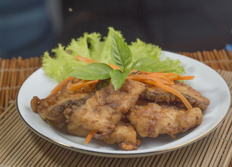 A fried food and herb on plate.
